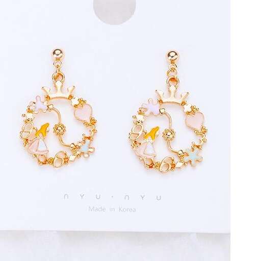 a pair of earrings with yellow gold plated stones and orange seed beads.