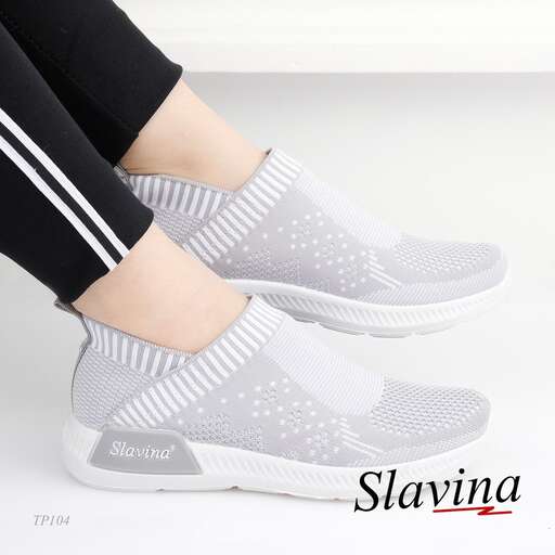 a woman's feet in gray and white sneakers