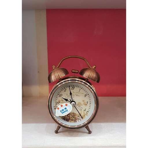 a clock with a picture of a clock on a table.