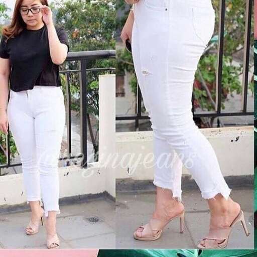 a woman in white jeans and a black shirt.