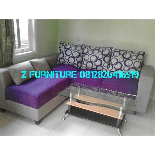 a small bed with a purple mattress and a purple pillow