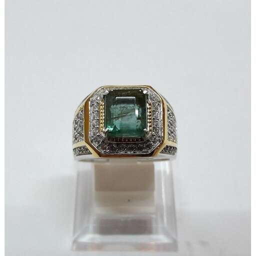 a ring with a green diamond