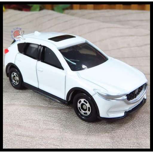 a toy car with a ribbon on the front and side.