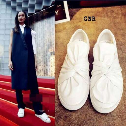 a model in a long coat and white shoes