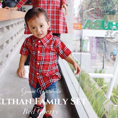 a boy in a red plaid shirt