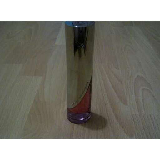 a glass vase on a wooden floor.