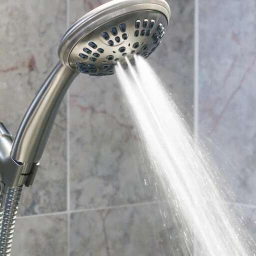 a shower head with a water running down it.