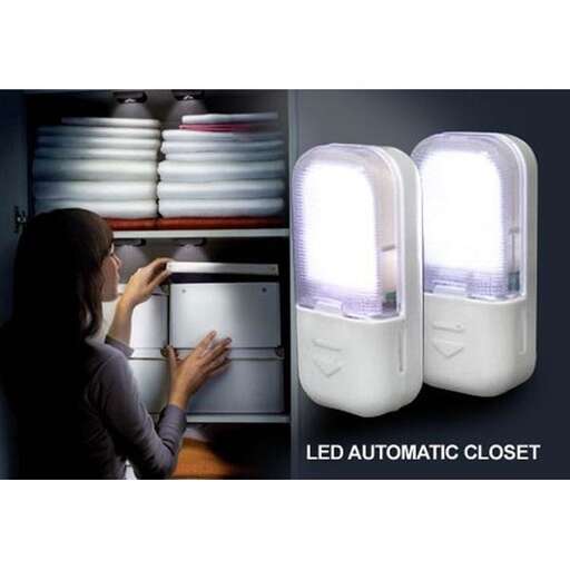 a woman looking at a light fixture.