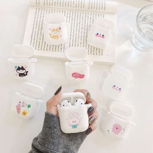 a child's hand holding a cup of tea and a picture of a cat in a baby's hand.