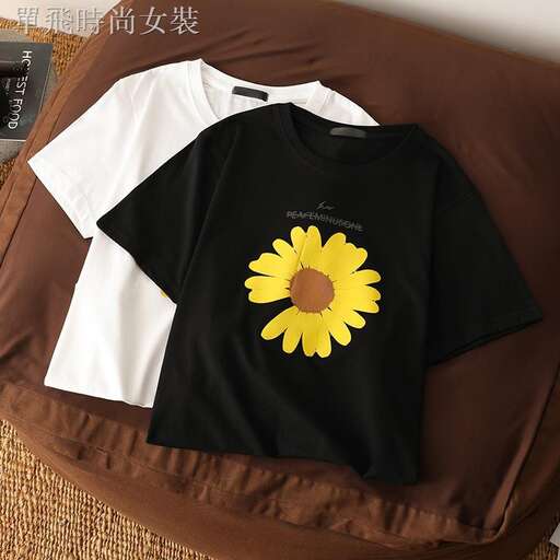 black and white t - shirt with a yellow flower on the front.