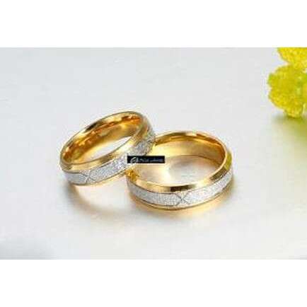 a pair of gold wedding rings