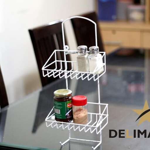 a small metal tray with spices on a glass table.