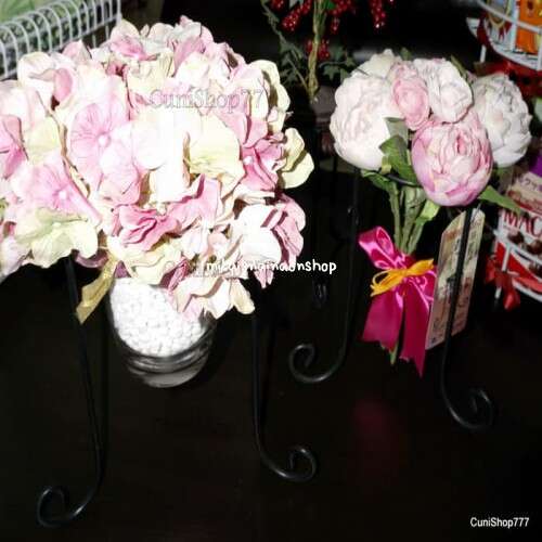 a couple of vases with flowers on a table.