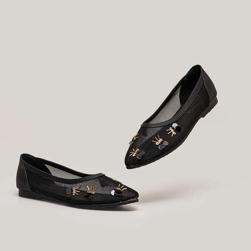 a pair of black leather slip - on shoes