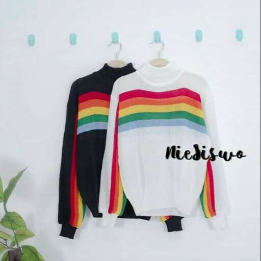 a rainbow striped sweater with a long sleeved shirt on the front.