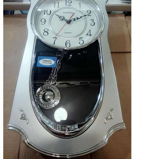 a silver clock with a chain on it.