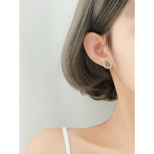 a close up of the earring in a woman's ear.