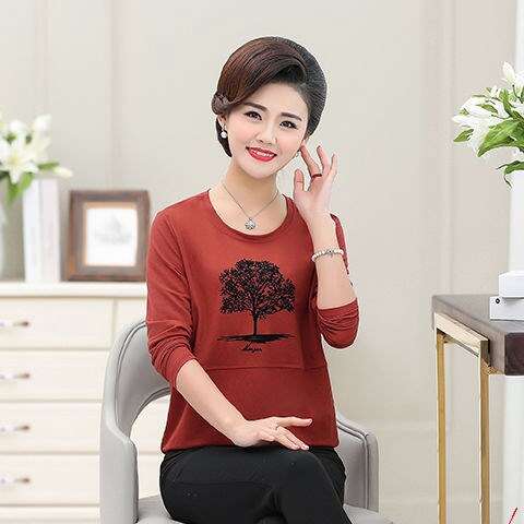 a woman sitting on a chair talking on a cell phone.