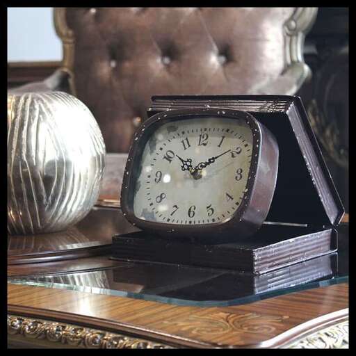 a clock sitting on top of a table.