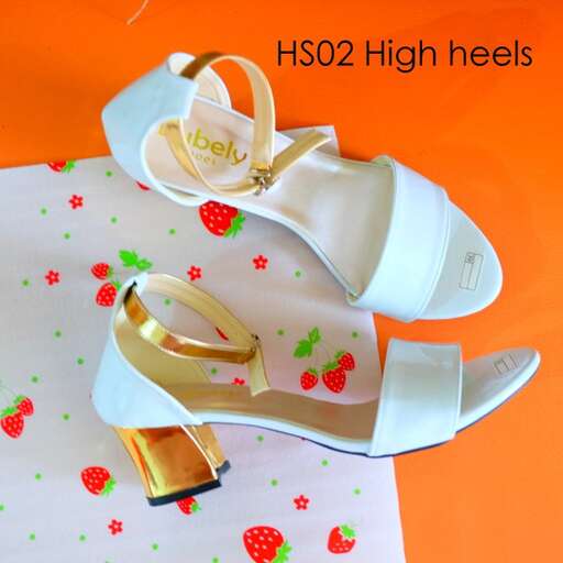 a pair of white shoes with a floral design on the bottom.