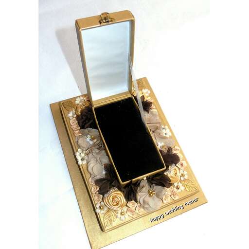 a small box of black glass and gold flowers in a gold box.