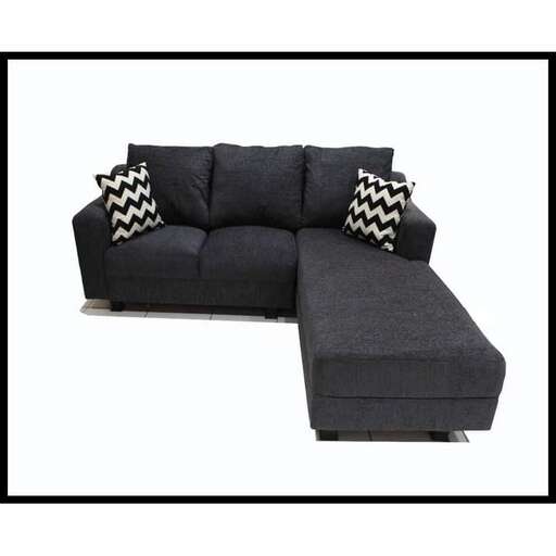 a black sofa with a white and black pillow.