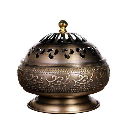 a brass lid with a metal decoration on it.