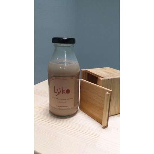 a bottle of milk and a wooden box on a table.