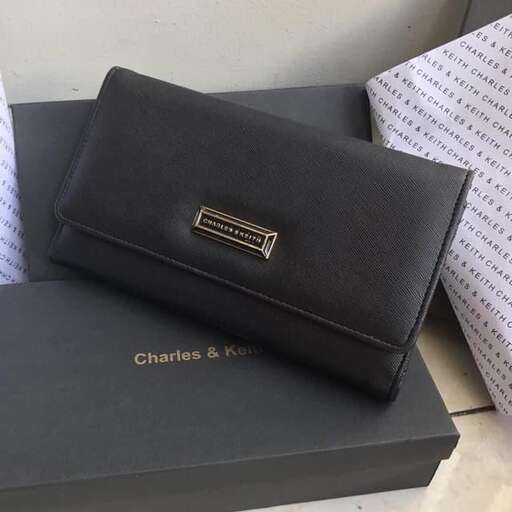 a black leather wallet with a gold logo on the front.