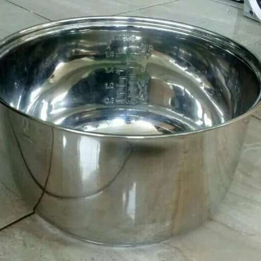 a stainless steel bowl with a hole in it.