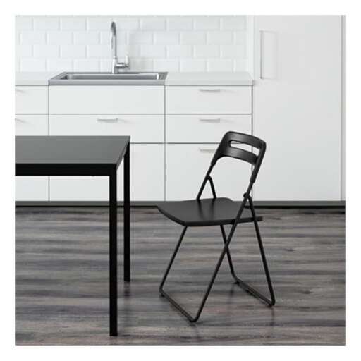 a chair that is sitting in front of a sink.