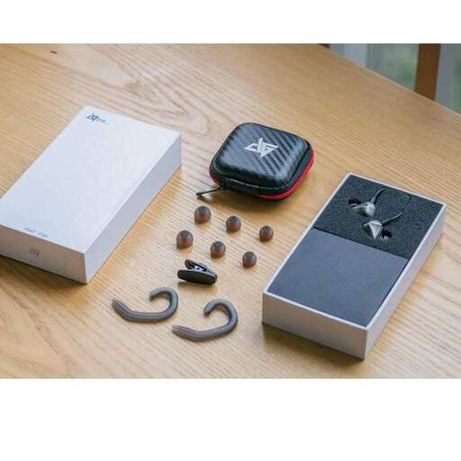 a cell phone, a box, a box and a cell phone on a table.