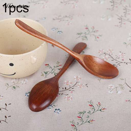 a wooden spoon and spoon on a table cloth.