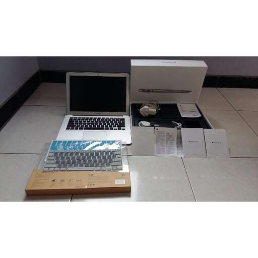 a laptop computer sitting on top of a wooden desk.