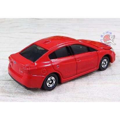 a small red car with black wheels.