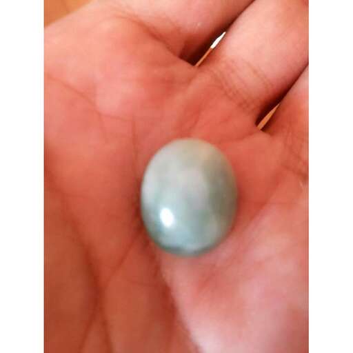 a blue stone in a hand