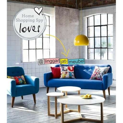 a living room with a blue couch and a coffee table.