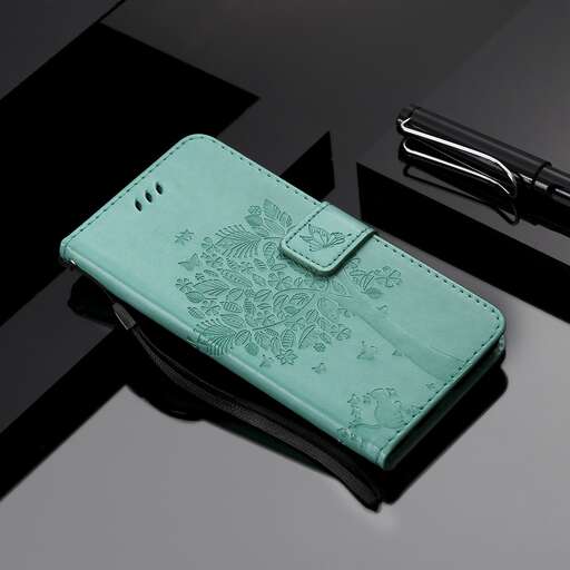 a small turquoise purse with a handle on a table.