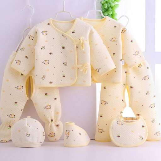 a baby's outfit made of cotton and a teddy bear