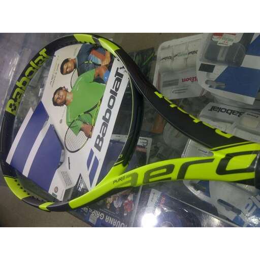 a tennis racket is sitting on a plastic surface.