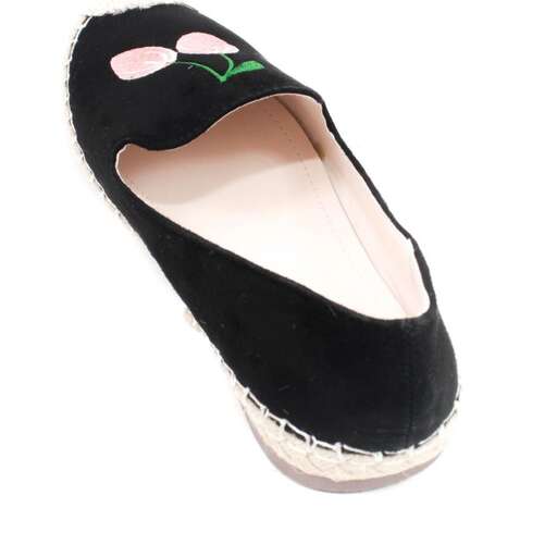 a black shoe with a green heart on the sole.