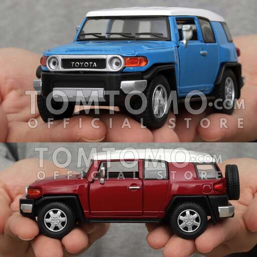 a hand holding a toy car with a blue body.