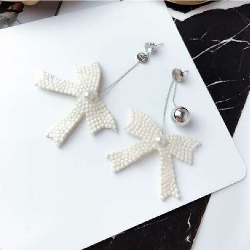white baby ribbon necklace with white ribbon and silver bow.