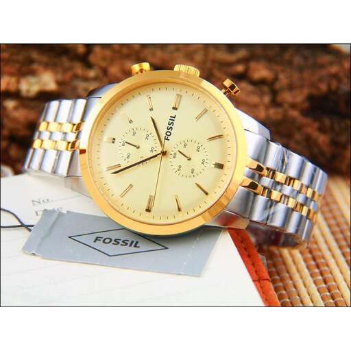 a gold watch with a silver band on it.