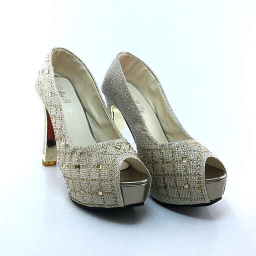 a pair of shoes with a gold beaded strap.