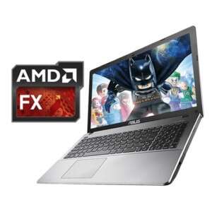 a laptop computer with a batman logo on the screen.