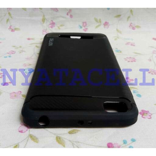 a black cell phone with a white cover on a floral print.