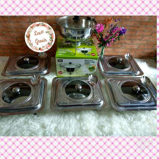 a table with a bowl and pans on it