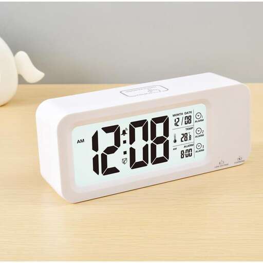 a clock that is on a table with a white face.