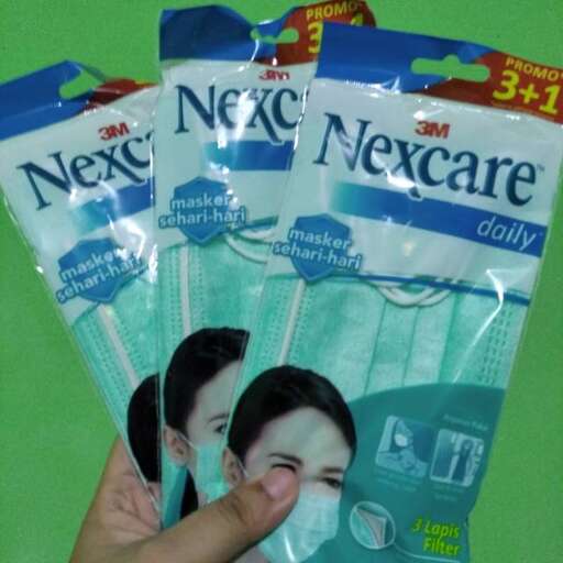 a person holding a package of toothpaste bags.